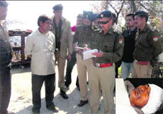 The SP (city) questions a man regarding a murder case in Mussoorie on Tuesday; and (inset) injured Ram Singh (85) in a hospital.