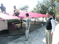 MDDA officials demolish an illegally constructed tin roof in Mussoorie 