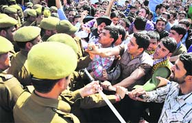 Members of the National Youth Corps scuffle with the police during a protest in Jammu on Tuesday
