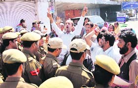 Protesters scuffle with the police in Jammu on Tuesday