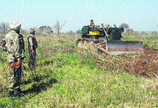 BSF men cultivating barren land along the border in the RS Pura sector in Jammu.