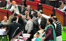 NC members stage a protest in the Assembly, demanding an apology from PDP MLA Muzaffar Hussain Baig, on Tuesday. 