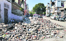 Debris dumped on a road at Jawahar Nagar Camp in Ludhiana.