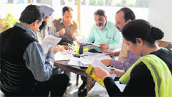 The flying squad examines answer sheets and the copying material recovered from students at the Lahore Khalsa Senior Secondary School for Boys in Jagraon on Tuesday.