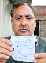 Ashok Kumar shows the receipt of cash that he deposited in a bank. 