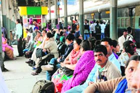 Passengers wait for the arrival of trains at the railway station in Amritsar on Wednesday