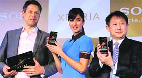 Bollywood actress and Sony India brand ambassador Katrina Kaif flanked by Dennis Van Schie (L), corporate vice president & head of sales & marketing, Sony Mobile Communications, and Sony India MD Kenichiro Hibi (R) at the India launch of the Sony Xperia Z smartphone in New Delhi on Wednesday