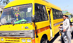 Students board a bus after their school bus was impounded in Mohali on Wednesday