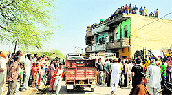 People gather outside the house where the crime took place at Matour village in Mohali on Wednesday