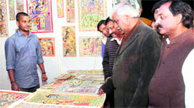 Sports Minister Dinesh Aggarwal inspects paintings at the Gandhi Shilp Mela at Parade Ground in Dehradun on Wednesday.