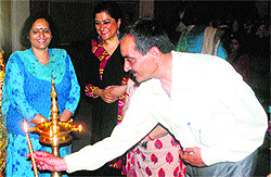 A lamp being lighted during a symposium on Role of Women in the 21st century to mark International Womens Day at Women Studies Centre of GCW, Gandhi Nagar, in Jammu on Wednesday