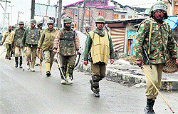 Security personnel patrol a street at Budshah chowk after curfew was imposed under 10 police stations