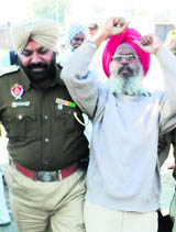 A police official detains a union activist at Jagraon on Wednesday.