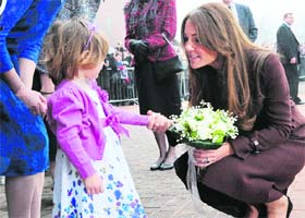 Catherine, the Duchess of Cambridge, receives a bouquet at the National Fishing Heritage Centre Grimsby in England on Tuesday