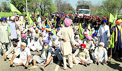 Farmers sit on dharna near Bathinda. The farmers had planned to disrupt the movement of traffic