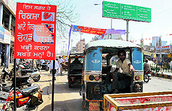 Auto-rickshaws remain parked on the road connecting the railway station to the Mall despite the board installed by the corporation that prohibits them from doing so