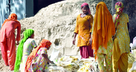 Women labourers work on the eve of International Women's Day in new Delhi on Thursday.