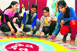 Students of DBS College make rangoli in a competition during Union Week celebrations in Dehradun on Thursday
