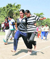 Students participate in three-leg race on the concluding day of the annual sports meet of Government Post Graduate College in Karnal. 