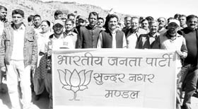 BJP workers led by district president Rakesh Jamwal take out a procession at Nihari on Thursday.