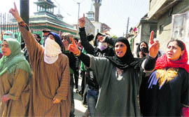 Women raise slogans at Batamaloo in Srinagar on Thursday to protest against the killing of a youth in Baramulla.