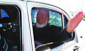 Separatist leader Syed Ali Shah Geelani waves to people after his arrival in Srinagar on Thursday from New Delhi.