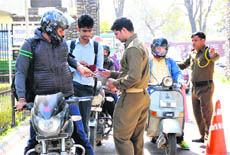 A security man verifies documents on the main gate of the university campus in Jammu on Thursday.