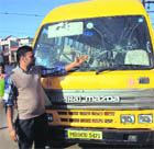 The driver of the bus shows the smashed windshield in Ludhiana on Thursday. 