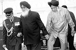 Gulzar Singh Ranike with Chief Minister Parkash Singh Badal after taking oath as Cabinet Minister at the Raj Bhawan in Chandigarh on Thursday
