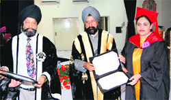 Vice-Chancellor Dr Ajaib Singh Brar (centre) gives away degree to a student at GNDU in Amritsar on Friday while Dr Indeerjit Singh (left), Registrar, looks on. photo: Vishal Kumar