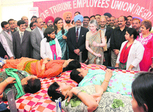 The Tribune Trust President, Justice SS Sodhi (retd), and his wife, Bonny Sodhi (centre), during a blood donation camp organised by The Tribune Employees Union to mark International Womens Day at the Tribune office, Sector 29, Chandigarh, on Friday.