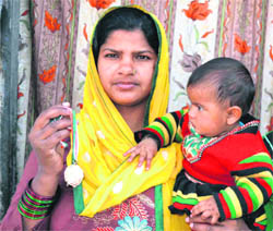 National Bravery Award winner Babli, along with her daughter, shows her medal at her home at Jwalapur in Haridwar on Friday.