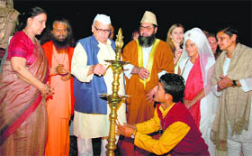 Governor Aziz Qureshi lights a lamp at the conclusion of the International Yoga Festival at Rishikesh.