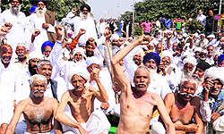 BKU activists block a road near the mini-secretariat in support of their demands in Karnal on Friday