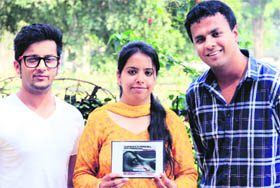 Students of Doaba College Gurmoh, Gunjan Kapoor and Robin Bansal with a CD of the song, Nanhi Pari, dedicated to the victim of the Delhi gang rape victim, in Jalandhar on Friday.