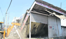 An earthmoving machine razes encroachments on Chandigarh Road in Ludhiana on Friday.