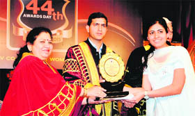 Rajat Agarwal, DC (centre) and Neelam Kamara, principal, give away award a girl student at the BBK DAV College for Women in Amritsar on Saturday.