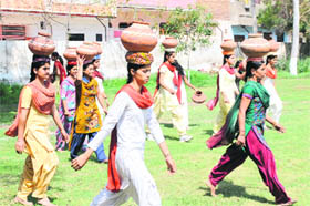 Students take part in a pot race during the sports meet held on the Regional Campus of Punjabi University in Bathinda on Saturday.