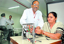 Dr Raman Gupta attends to a patient at the Physiotherapy Centre of the Civil hospital, 