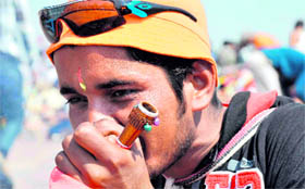 A Kanwariya smoking a chillum on way to Haridwar to fetch Ganga water on Saturday.