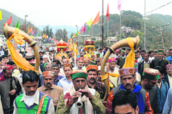 Devotees with local deities come to Mandi on Saturday ahead of the Mahashivratri fair which will start on Monday. Photo: Jai Kumar