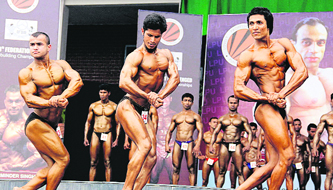  Bodybuilders flex their muscles during the Mr India-13th Federation Cup at Lovely Professional University, near Jalandhar, on Saturday.