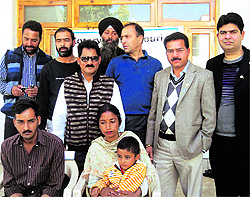 The child with his parents and members of the Rotary Club in Jammu on Saturday