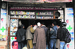 People gather outside a chemist shop to buy medicines in Srinagar after six days of curfew, on Saturday