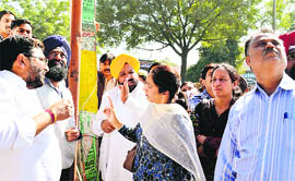 Akali councillor Sukhdev Singh Gill (sporting yellow turban) argues with ATO Kamaljit Kaur during an anti-encroachment drive on Chandigarh Road.