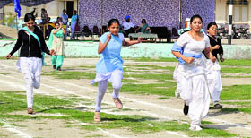 Girls participate in a 100-m event on Saturday.