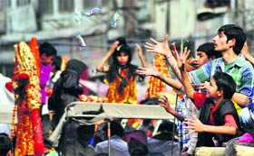 Devotees partake of prasad during a shobha yatra on the eve of Shivratri in Ludhiana on Saturday.