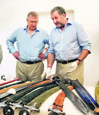 Britains Prince Andrew (L) looks at swords during an auction in Jodhpur on Saturday.