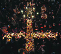 Worshippers gather around candles stuck to jars with honey, during a religious mass in the church of the Presentation of the Blessed Virgin in the city of Blagoevgrad.