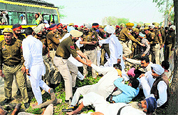 Farmers being arrested by the police near Naruana village, situated on the Badal road, on Sunday. They were on their way to Bathinda to stage a protest
